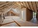 Unfinished attic space showing wooden beams and insulation, ready for customization and expansion at 3860 Rajean Dr, Lawrenceville, GA 30044