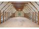 Bright attic space featuring natural light, wooden beams, and insulation, ideal for customization at 3860 Rajean Dr, Lawrenceville, GA 30044