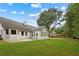 Spacious backyard with ample green space and a view of the home's exterior at 3860 Rajean Dr, Lawrenceville, GA 30044