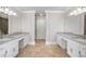Spacious bathroom offers dual vanities with granite countertops and tiled floors at 3860 Rajean Dr, Lawrenceville, GA 30044