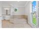 Bright bathroom features a soaking tub, vanity with granite countertop, and tiled floors at 3860 Rajean Dr, Lawrenceville, GA 30044