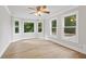 Bright bedroom features hardwood floors, crown molding, and multiple windows offering natural light at 3860 Rajean Dr, Lawrenceville, GA 30044