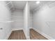 A walk-in closet with adjustable shelving and modern floors at 3860 Rajean Dr, Lawrenceville, GA 30044