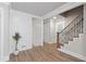 Bright foyer with wood floors leading to a staircase with metal accents and a view of the other rooms at 3860 Rajean Dr, Lawrenceville, GA 30044