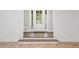 Bright foyer showcasing tile flooring, paneled walls, wood flooring steps, and a white front door at 3860 Rajean Dr, Lawrenceville, GA 30044