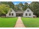 Charming home with a manicured front yard, walkway, and inviting covered porch at 3860 Rajean Dr, Lawrenceville, GA 30044