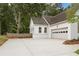 Attached garage and a spacious driveway providing ample parking space and convenient access to the home at 3860 Rajean Dr, Lawrenceville, GA 30044