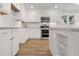 Modern kitchen featuring white cabinetry, stainless steel appliances, and granite countertops at 3860 Rajean Dr, Lawrenceville, GA 30044