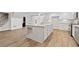 Kitchen with granite countertops, white cabinetry, stainless appliances and an island with bar seating at 3860 Rajean Dr, Lawrenceville, GA 30044