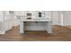 Close up of the kitchen with granite countertops, white cabinetry and an island with bar seating at 3860 Rajean Dr, Lawrenceville, GA 30044