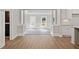 Open living room with white columns, wood flooring, a view of the dining room and kitchen at 3860 Rajean Dr, Lawrenceville, GA 30044