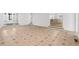 Open living room with tile flooring flowing into the front entrance and a view of the kitchen at 3860 Rajean Dr, Lawrenceville, GA 30044