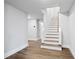 Newly carpeted staircase that leads to the upper levels with a painted handrail and modern floors at 3860 Rajean Dr, Lawrenceville, GA 30044