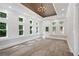 Sunroom with coffered ceiling, chandelier, and many large windows at 3860 Rajean Dr, Lawrenceville, GA 30044