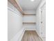 Walk-in closet with built-in shelves and hardwood floors, offering ample storage space at 3860 Rajean Dr, Lawrenceville, GA 30044
