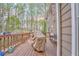 Wide deck features a grill covered from the elements, chairs, and views of the backyard at 4327 Saint Michaels Dr, Lilburn, GA 30047