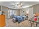 Cozy bedroom with neutral walls, carpet, ceiling fan, a comfortable bed, and a TV on the wall at 4327 Saint Michaels Dr, Lilburn, GA 30047