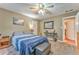 Cozy bedroom with carpet, ceiling fan, and comfortable bed with blue striped comforter at 4327 Saint Michaels Dr, Lilburn, GA 30047