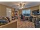 Relaxing bedroom with a ceiling fan, neutral walls, a cozy couch and a desk for a dedicated office space at 4327 Saint Michaels Dr, Lilburn, GA 30047