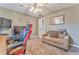 Cozy bedroom with a ceiling fan, neutral walls, carpeted floors, and a comfortable seating area at 4327 Saint Michaels Dr, Lilburn, GA 30047
