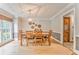 Traditional dining room with hardwood floors, wainscoting, and a charming chandelier at 4327 Saint Michaels Dr, Lilburn, GA 30047