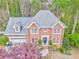 Charming two-story brick home featuring manicured landscaping and an attached two-car garage at 4327 Saint Michaels Dr, Lilburn, GA 30047