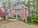 Beautiful brick home boasting a manicured lawn, flowering shrubs and an attached two car garage at 4327 Saint Michaels Dr, Lilburn, GA 30047