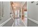 Stylish foyer with marble tile, wooden staircase, and decorative lighting fixture at 4327 Saint Michaels Dr, Lilburn, GA 30047