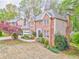 Beautiful brick home featuring a well-kept lawn, a two-car garage, and lush landscaping at 4327 Saint Michaels Dr, Lilburn, GA 30047
