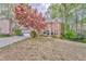 Charming two-story home with a well-manicured lawn, a two-car garage, and mature trees at 4327 Saint Michaels Dr, Lilburn, GA 30047