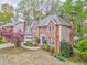 Charming two-story brick home featuring a well-manicured front yard and an attached two car garage at 4327 Saint Michaels Dr, Lilburn, GA 30047