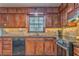 Well-equipped kitchen with wooden cabinets, granite counters, and stainless steel appliances at 4327 Saint Michaels Dr, Lilburn, GA 30047