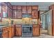 Cozy kitchen featuring wooden cabinets, granite counters, and stainless steel appliances at 4327 Saint Michaels Dr, Lilburn, GA 30047