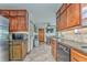 A functional kitchen boasts wooden cabinets, stainless steel appliances and an adjacent dining area at 4327 Saint Michaels Dr, Lilburn, GA 30047