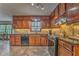 Cozy kitchen with dark wood cabinets, granite countertops, and modern appliances at 4327 Saint Michaels Dr, Lilburn, GA 30047