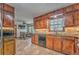 Warm kitchen features dark wood cabinets, granite countertops, and an eat-in area at 4327 Saint Michaels Dr, Lilburn, GA 30047