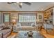 Living room area featuring hardwood floors, neutral colors, and a large window with natural light at 4327 Saint Michaels Dr, Lilburn, GA 30047