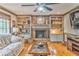 Bright living room featuring a brick fireplace with built-in shelves and hardwood floors at 4327 Saint Michaels Dr, Lilburn, GA 30047