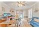 Bright home office with hardwood floors, a ceiling fan, a large desk, and a comfortable sofa at 4327 Saint Michaels Dr, Lilburn, GA 30047