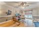 Bright home office with hardwood floors, a ceiling fan, a large desk, and a view of the outdoors at 4327 Saint Michaels Dr, Lilburn, GA 30047