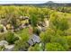 Aerial view capturing a home with surrounding mature trees and lush greenery, set against the backdrop of rolling hills at 503 Duke Dr, Marietta, GA 30066