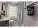 Bathroom featuring hexagon tiles, black hardware, and white fixtures at 503 Duke Dr, Marietta, GA 30066
