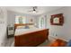 Bedroom with a wooden bed frame, plush carpet and large windows at 503 Duke Dr, Marietta, GA 30066
