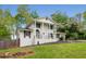 Charming two-story white brick home with black shutters, complemented by a well-manicured lawn and mature trees at 503 Duke Dr, Marietta, GA 30066