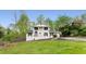 Two-story white brick home with a well-maintained lawn and landscaped garden, offering inviting curb appeal at 503 Duke Dr, Marietta, GA 30066