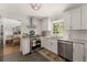 Well-lit kitchen showcasing stainless steel appliances, including a gas range, complemented by white cabinetry and subway tile backsplash at 503 Duke Dr, Marietta, GA 30066