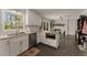 Bright kitchen featuring white cabinets, stainless steel appliances, and a window overlooking a lush green landscape at 503 Duke Dr, Marietta, GA 30066