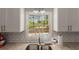 Kitchen with a window view of a pool with granite countertops and white cabinets at 503 Duke Dr, Marietta, GA 30066