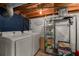 Laundry room featuring a washer, dryer, utility shelving, and wood look flooring at 503 Duke Dr, Marietta, GA 30066