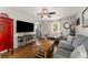 Cozy living room with hardwood floors, large TV and comfortable seating arrangement at 503 Duke Dr, Marietta, GA 30066